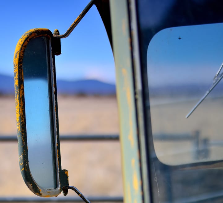 Rusty river's side rear view mirror on 1955 Carpenter / Steelcraft school bus 